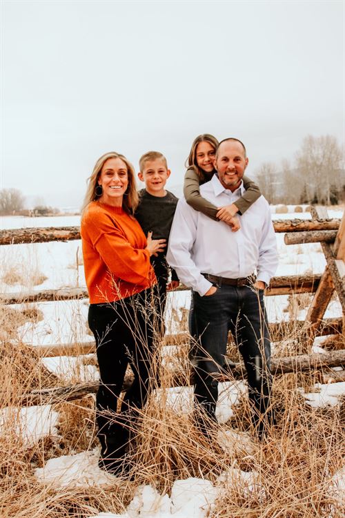 family standing in front of fence